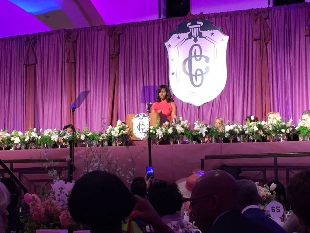 First Lady Michelle Obama makes remarks to an enthusiastic crowd at the Washington DC Hilton, as she is surrounded by American grown flowers.