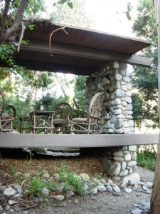 Redwood and river rock form a rustic gazebo