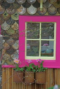 With shingles made from flattened tin can lids and hot pink trim, this is an outrageous outhouse!