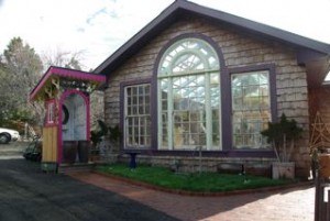 Cute Outhouse (left) outside the gorgeous conservatory, built by Scotty Thompson of Living in the Garden