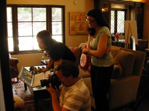 On location: Gary Moss, photographer (kneeling), as he perfects his shot in the family room. His assistant Pam is to his left; 805 Living editor Lynne Andujar is at right