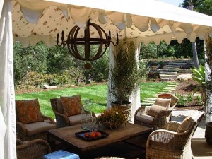 Create an outdoor room with a Sunbrella fabric tent lined with sheer panels and Morrocan print fabric on ceiling