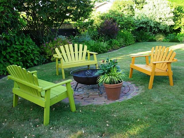 Colorful Adirondack benches, each painted a different color to match the foliage