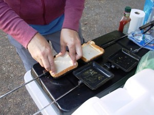 Jennifer gets the fixin's ready for a pocket pizza, camping style