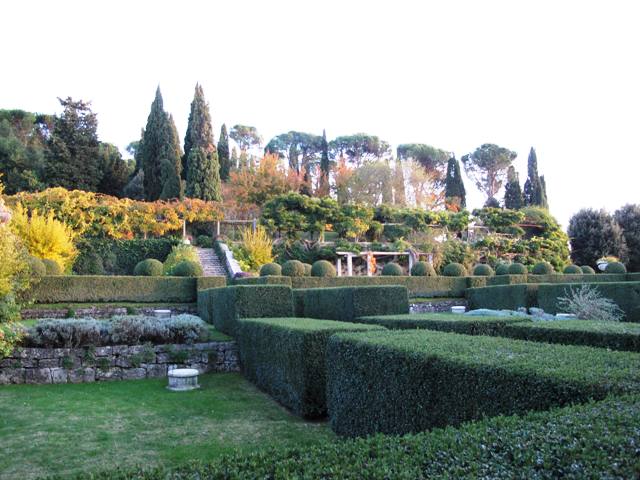 The late afternoon, autumn light casts a honey-colored glow over La Foce's terraces