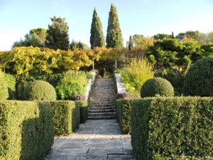 The stone steps of La Foce's terraced garden draw the eye upward, towards two large Italian cypresses