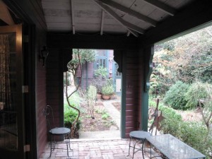 Finished with a brick floor and fanciful bracket-trim, it's a sheltered spot to sit in any weather.