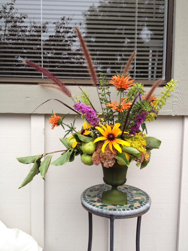 Kathleen used persimmons, sedum, grasses, assorted salvia, butterfly bush blossoms, and lions beard. Stunning~