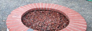"Before," a brick-capped fire pit.