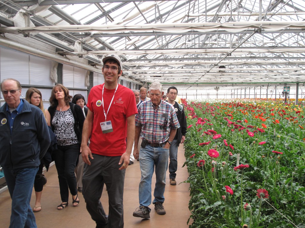 Ivan Van Wingerden of Ever-Bloom in Carpinteria, California, tours visitors through the gerbera greenhouses during the annual open garden event bringing consumers to flower farms.