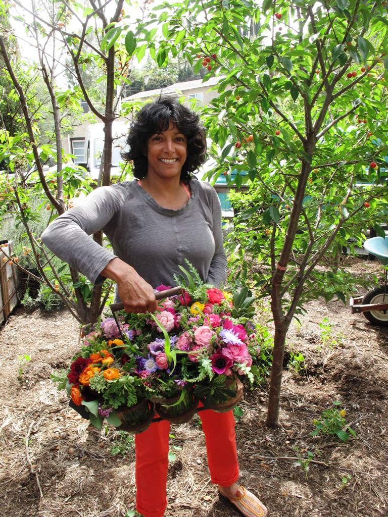 I snapped this cute photo of Tara and her flowers on April 10th. She was preparing luscious bouquets for her CSA deliveries.