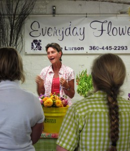 Vivan often takes times to educate her customers and visitors to the Seattle Wholesale Growers Market. 