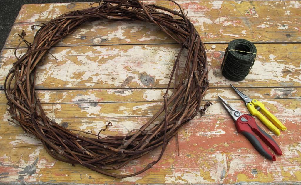 Getting started with a repurposed grapevine wreath, bind wire and snips.