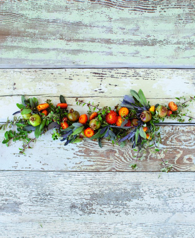 A gorgeous garland with cotoneaster branches, pomegranates, purple sage and strawflowers.