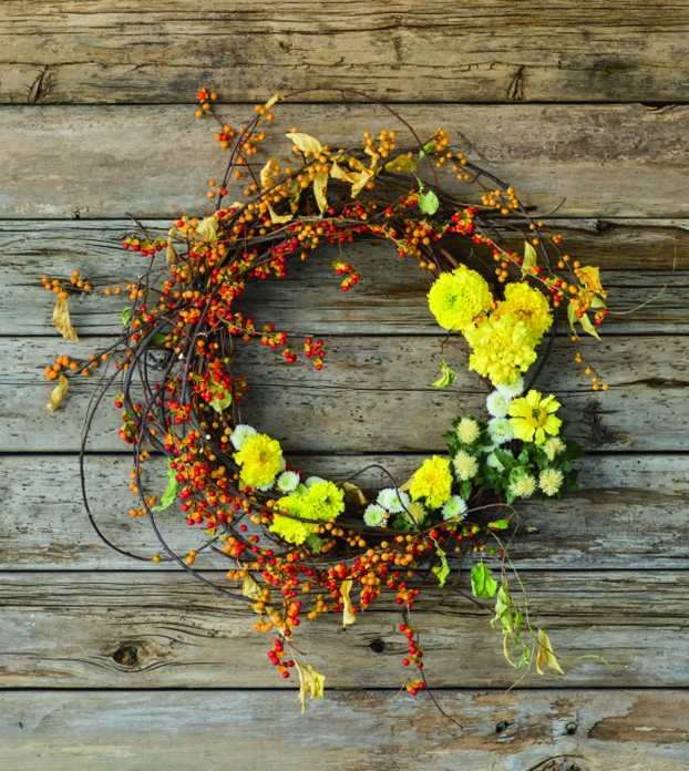 Bittersweet wreath with fall chrysanthemums, marigolds and safflowers.