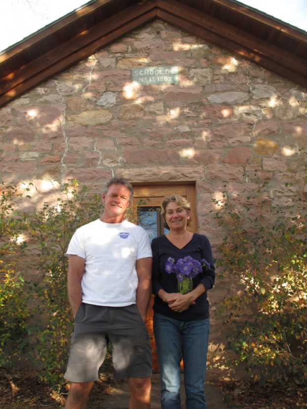 The Fresh Herb Co.'s Chet and Kristy Anderson in front of their home, a renovated circa 1889 stone schoolhouse.
