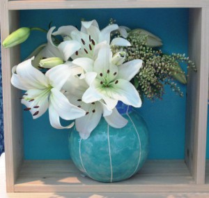 The teal and white "bubble vase" by Kristin Nelson of Vit Ceramics inspired the painted "back" of each nook of thd curio cupboard.