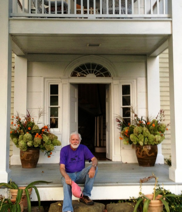 Bob Wollam, seated on the front porch of the historic farmhouse in Jeffersonton, Virginia where Wollam Gardens is based.