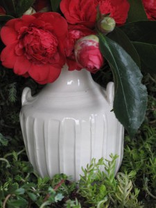 Another closeup with camellias against the creamy white glaze