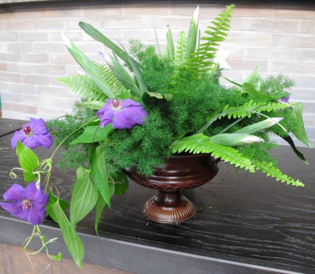 An all Florida arrangement featuring three types of foliage and ferns combined with trailing clematis.