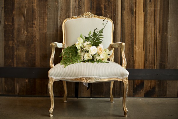 A Bash & Bloom emerald green and white bouquet displayed in an ornate chair with photography (c) Courtney Bowlden Photography 