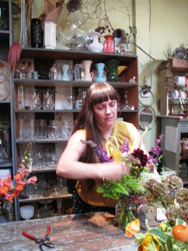 Hilary Holmes, in action as she designs a summer bouquet in her North Portland shop.