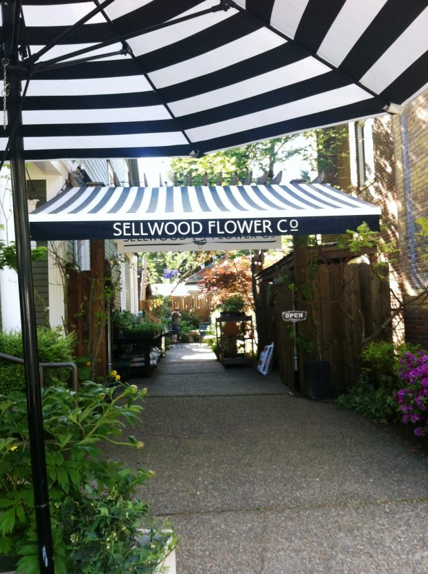 Love the black-and-white awning stripes, which are part of Sellwood Flower Co.'s visual brand evoking a Parisian flower shop.