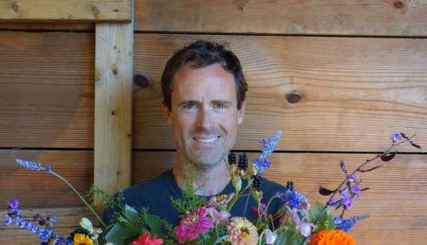 A happy designer, holding an lush, abundant arrangement that he created for an upcoming issue of Country Gardens magazine 