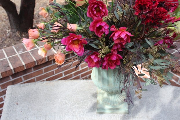 Love the hot pink dahlias  paired with these quiet peach roses. Against the dark foliage, they look even more stunning.
