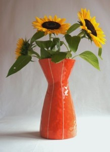 Eve, the lovely, sensual vase by Kristin Nelson, shown in coral glaze