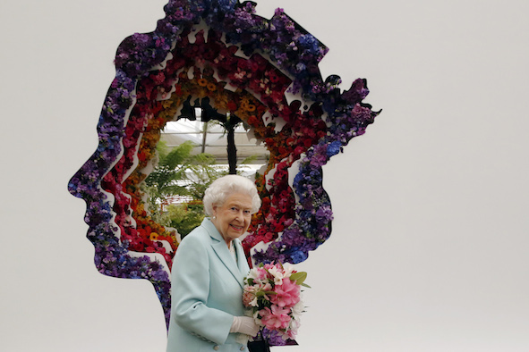 Britain's Queen Elizabeth views a floral tribute to her for her 90th anniversary, desinged by florist Veevers Carter, on the New Covent Garden Flower Market stand at the RHS Chelsea Flower Show 2016 in London, UK Monday May 23, 2016. RHS / Luke MacGregor