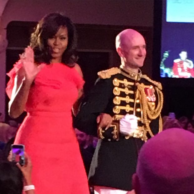 The awesome Michelle Obama with her military escort.