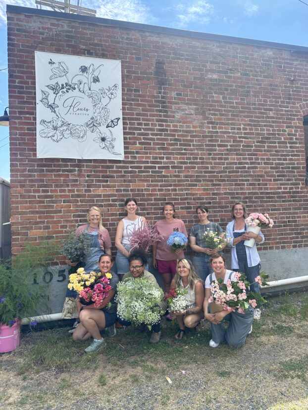 The Flower Farmers gathered in front of Fleurs Creative