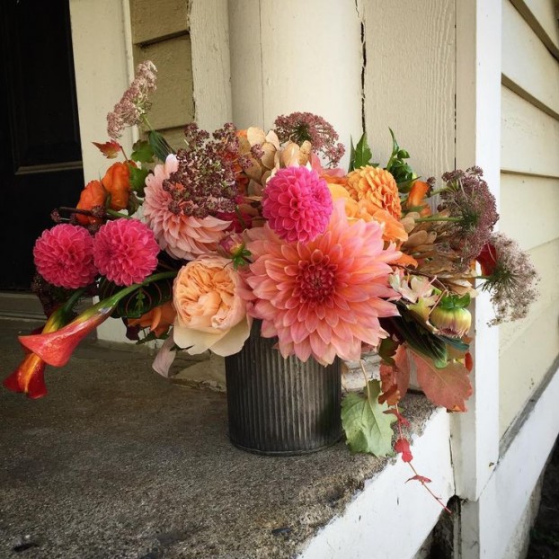 A compote piece filled with Michigan grown dahlias from Summer Dreams Farms in Brandon Twp., Michigan. Liz also used foraged vine and tree seeds from Parsonage Event's studio yard.