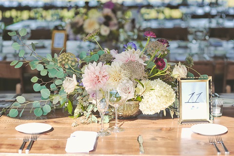 A low centerpiece filled with Michigan grown hydrangea, dahlias and Queen Ann's lace. Photo Credit: A Girl In Love Photography