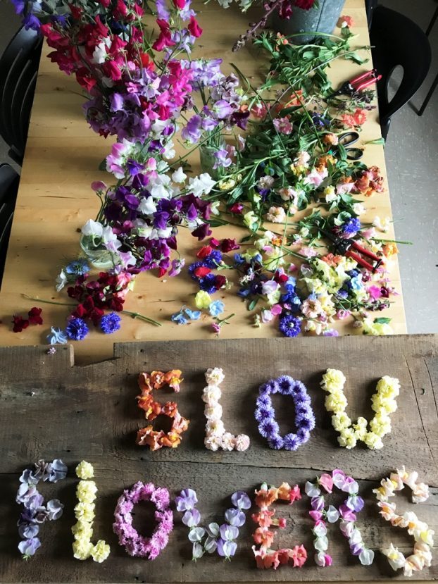 Slow Flowers spelled out in flower petals