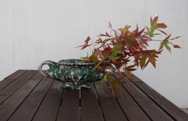 Step One: Start with a few branches of Liquidambar - a sure sign of fall! Place them off-centered to exaggerate the width of the urn.