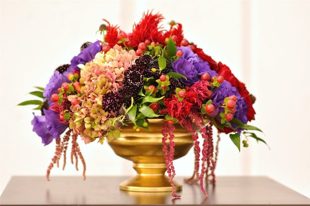 Rich floral hues and a gold vessel, by Flower Duet.