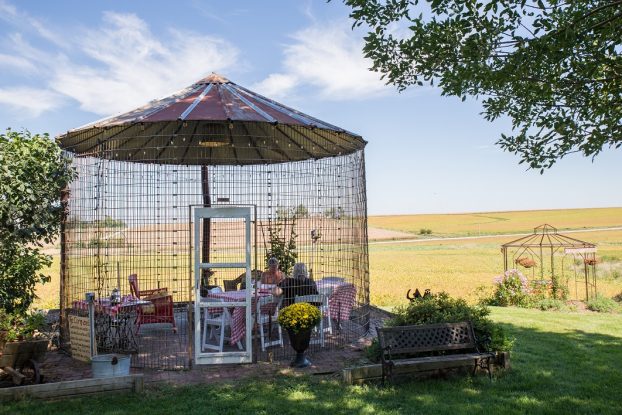 Called the "corn-zebo," this charming open-air structure is fashioned from a former corn-storage silo and decorated with a whimsical door and roof. Here's where tea is served, with views of farm fields beyond. 
