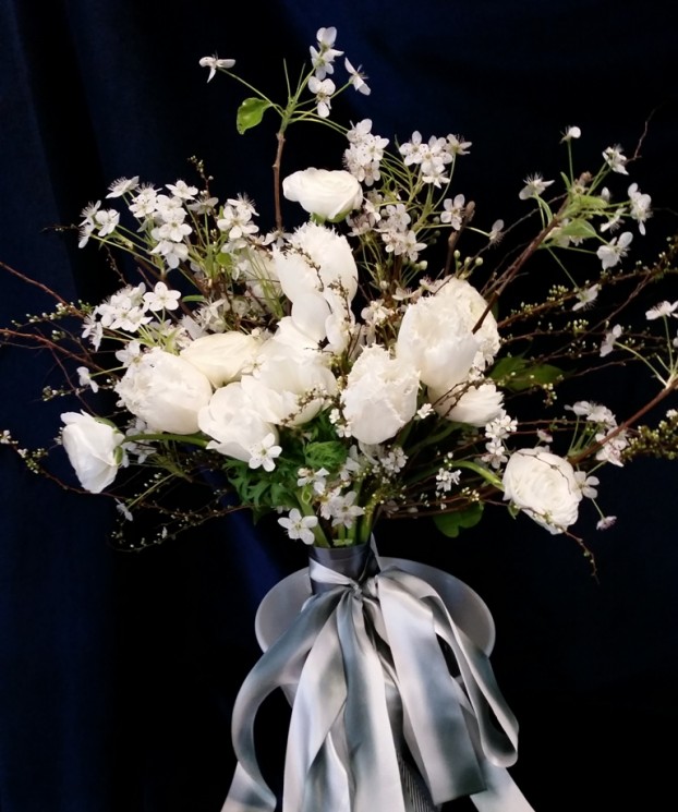 The winter bridal bouquet with flowering branches, tulips and anemones.