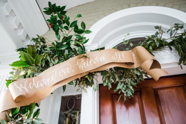 Entertain holiday guests with a greeting that trims the front door. Christy Hulsey and Amanda Currier of Colonial House of Flowers in Statesboro, GA embellished the front door with a garland of local greenery and berries that last the entire month of December. 
