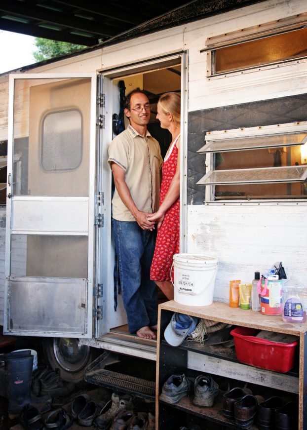 This young couple has been living in their renovated 77-foot pull-behind trailer while building their homestead. Photo by Bethany Cubino, Chasing Skies Photography